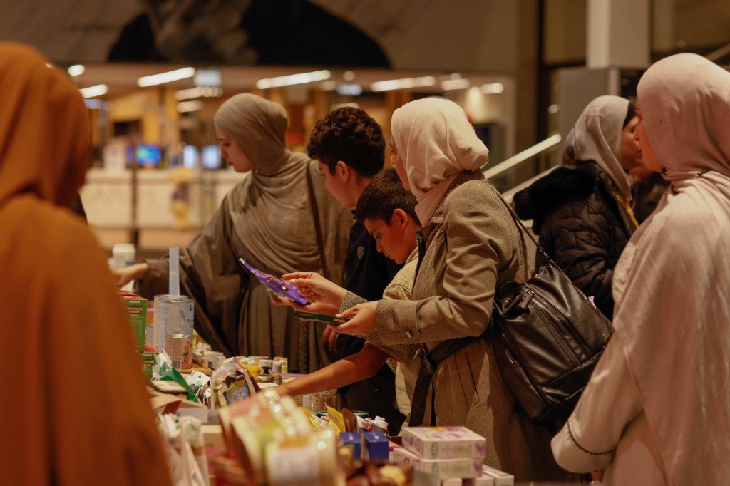 Families browsing natural products at the community marketplace