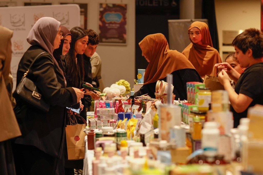 Vibrant marketplace scene with attendees exploring wholesome products